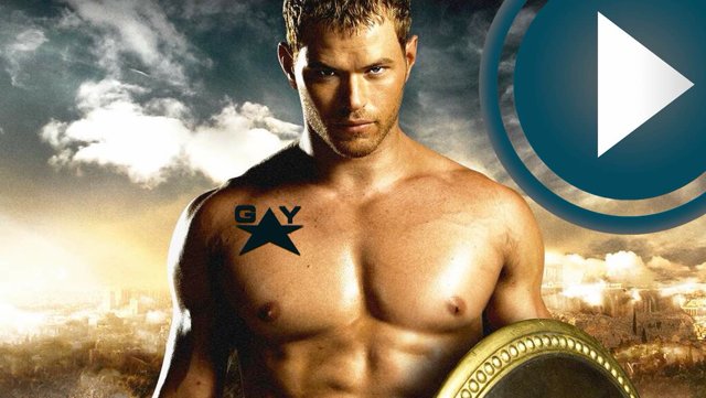 Shirtless man with GAY tattoo, holding shield. Gay travel advice video thumbnail. Travel inspiration for gay men. 502617509_640.jpg