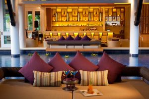 TropOut Gay Phuket Hotel Room: Luxury poolside lounge with cocktails, pillows, and a bar. Ideal for gay travel and relaxation in Thailand.