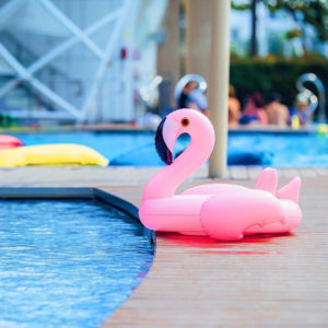 Pink flamingo floatie at W Hotels pool. Gay travel goals: relaxing at a stylish hotel. Summer vibes, travel advice.