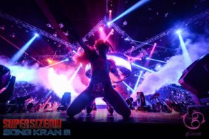 Gcircuit Hot Show: Dancer at Songkran 8 gay dance festival, Bangkok. Stage lights, crowd, and special effects. Gay travel advice.