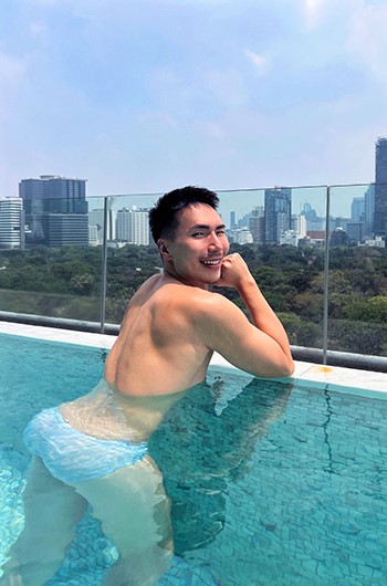 SO/ Bangkok Hotel: Gay man at luxury hotel's rooftop infinity pool in Silom, Bangkok. Best gay hotel for travelers.