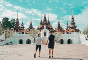 Gay Thailand Travel: Couple holding hands at Dharadhevi, Chiang Mai. Thailand travel for gay men. Romantic getaway in Thailand.