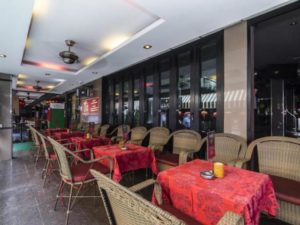 Copa Hotel's outdoor dining area. Gay-friendly hotel with tables set for guests, creating a welcoming atmosphere for gay travelers.
