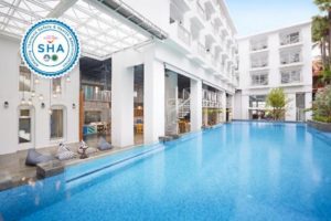 Lub d Phuket Patong gay-friendly hotel. Exterior view of the SHA-certified hotel with pool, bean bags, and white spiral staircase.