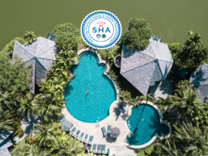 Aerial view of Peace Laguna Resort, a gay-friendly hotel. Pools, bungalows, and lush greenery create a tranquil Thailand getaway. SHA certified.