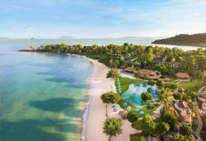 Aerial view of The Naka Island, a Luxury Collection Resort & Spa, Phuket. Gay-friendly hotel with beach, pool, and lush tropical landscape.