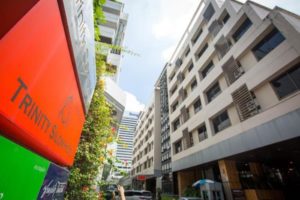 Trinity Silom Hotel, a gay-friendly hotel in Bangkok. Exterior view showcasing the hotel's facade and signage. Modern architecture in the Silom district.