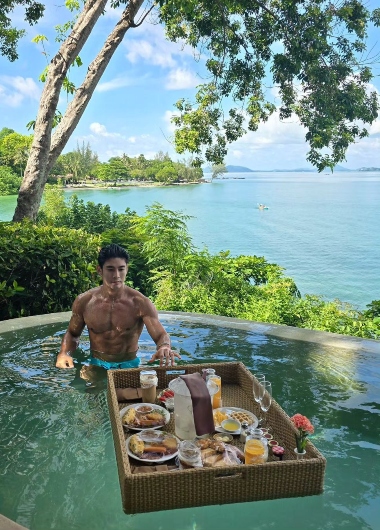 Gay Phuket beachfront villa at The Naka Island, a Luxury Collection Resort & Spa. Muscular man with floating breakfast in private pool.