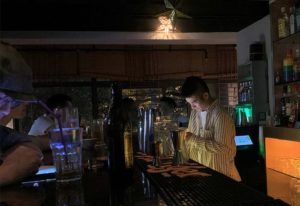 Rice Bar Shanghai cocktail bar: Bartender prepares drinks in gayborhood restaurant. Shanghai's nightlife scene for gay men.