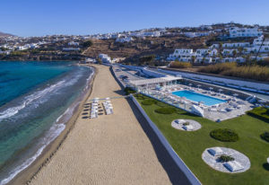 Mykonos Bay Resort & Villas beachfront view. Luxury gay hotel in Mykonos Town for gay travelers. Pool, beach, and whitewashed buildings.