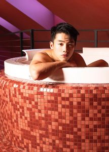 Stories Hotel Budapest: Man relaxing in a tiled jacuzzi. Best hotel for big group of friends. Gay travel advice for Budapest.
