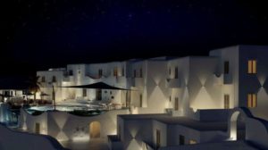 Absolute Mykonos Suites at night. Gay-friendly hotel with white buildings, pool, and stars. Luxury Mykonos travel for gay men.