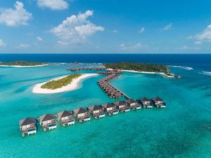 Anantara Veli Maldives Resort aerial view. Overwater bungalows stretch across turquoise waters. A gay-friendly hotel in the Maldives.