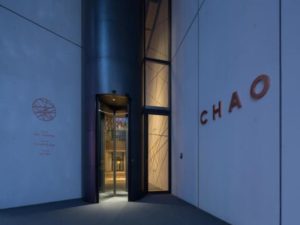 CHAO Sanlitun Beijing entrance. Gay-friendly hotel in Sanlitun, Beijing. Revolving door entry to the CHAO hotel. Modern architecture.
