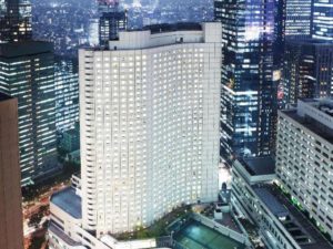 Hilton Tokyo, a gay-friendly hotel, at night. The hotel's lit windows stand out among the city's skyscrapers. A great choice for gay travelers.