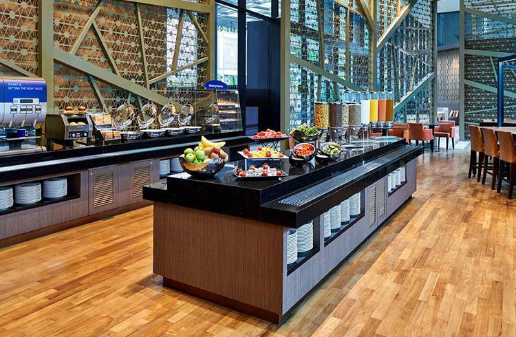 Breakfast buffet at Holiday Inn Express Singapore Clarke Quay, a gay-friendly hotel. Food includes fruit, cereal, and pastries. SG Clean Certified.