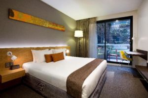 Gay-Friendly Hotel Jasper Boutique Hotel room. Modern design, king bed, balcony with chairs. Ideal gay travel accommodation.