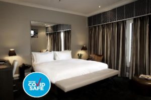 Kirketon Hotel Sydney guest room. Gay-friendly hotel with Covid-safe accommodations. Modern room with king bed and stylish decor.
