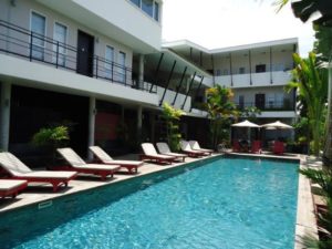 Men's Resort & Spa, a gay-friendly hotel. Swimming pool with lounge chairs. Tropical plants. Ideal for gay men's travel and relaxation.