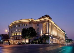 Rosewood Yangon, a gay-friendly, pet-friendly hotel. Evening view of the luxury hotel, showcasing its grand architecture and illuminated facade.