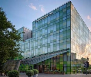 Exterior of The Opposite House Hotel, a gay-friendly hotel with a modern glass facade. A great choice for gay travelers.
