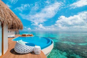 W Maldives gay-friendly hotel: Overwater bungalow with private pool overlooking the turquoise ocean. Perfect for gay couples' travel.