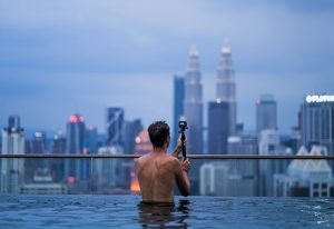 Gay traveler films Kuala Lumpur skyline from rooftop pool. Latest update on gay travel guide to Kuala Lumpur, Malaysia.