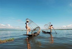 Yangon travel: Intha fishermen on Inle Lake, Myanmar, using traditional fishing techniques. Best gay things to do in Yangon, Myanmar.