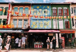 Singapore travel guide: Colorful buildings in Singapore's Chinatown, with lanterns strung across the street. A vibrant scene for gay travelers.