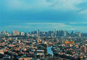 Gay Manila travel guide: A cityscape view of Manila, Philippines, showing the skyline and a river running through the urban area.