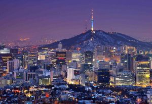 Seoul skyline at dusk. Gay travelers guide to Seoul, South Korea. Namsan Mountain and Seoul Tower in the background. Best travel guide.