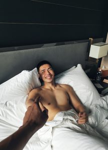 Gay man in InterContinental Singapore Robertson Quay hotel bed. Best gay hotels in Singapore City Center. Travel advice.