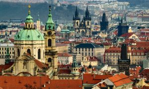 Prague skyline view. Red rooftops, towers, and domes. Gay travel guide for top gay hotels in Prague near gay bars and saunas this year.