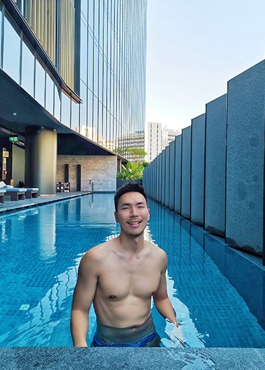 Gay traveler at InterContinental Singapore Robertson Quay's pool. Very cheap hotel, great for gay men's travel in Singapore.