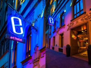 Bohem Art Hotel, a gay-friendly hotel. Exterior view at night with neon sign. A great choice for gay men travel.