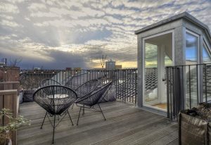 Gorki Apartments' pet-friendly terrace view. This gay-friendly hotel offers stylish outdoor spaces for relaxation and enjoying the city skyline.
