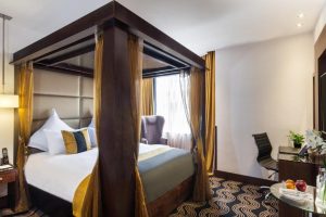 Gay-Friendly Hotel, The Piccadilly London West End: Luxurious four-poster bed in a stylish room. Ideal for gay travelers in London.