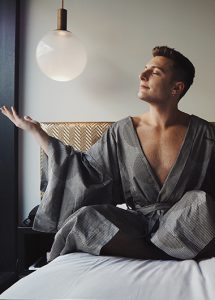 Gay man in robe at Nobu Hotel Shoreditch, London. Best gay hotels in London City Center. Gayborhood travel advice for gay men.