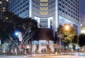 Carlton Hotel Singapore exterior at night. A gay-friendly hotel option with modern architecture and city views. Recommended for gay travelers.