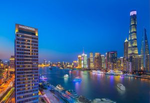 Hotel Indigo Shanghai On The Bund view at night. Gay-friendly hotel with skyline and river. Shanghai travel for gay men. Bund architecture.