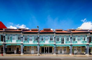 KēSa House by Oakwood, a gay-friendly hotel. Facade of the Unlimited Collection hotel with light blue walls and red tiled roofs in Singapore.