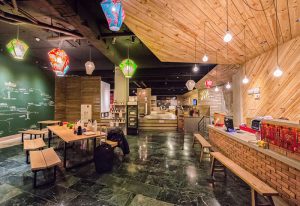 Meander Taipei Hostel Ximending lobby. Gay-friendly hotel with colorful lanterns, wooden accents, and a welcoming atmosphere for LGBT travelers.