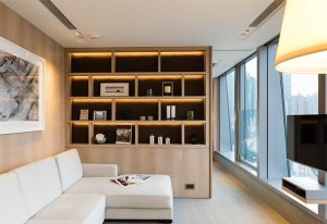 One96 gay-friendly hotel: modern living room with white sofa, stylish shelving, and city view. Ideal for gay men's travel in Hong Kong.