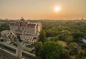 Rose Garden Hotel, a gay-friendly hotel. Exterior view of the hotel with a sunset in the background. A great choice for gay men travelers.