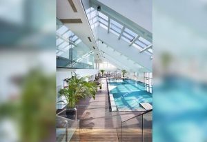 The Longemont Shanghai Hotel's indoor pool. Gay-friendly hotel with skylight, wood deck, and plants. A luxury travel experience in Shanghai.