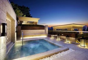 The Shilla Seoul gay-friendly hotel: outdoor jacuzzi with lanterns at dusk. Luxury travel for gay men in Seoul, South Korea.
