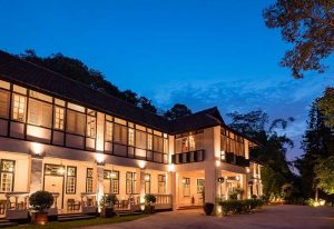 Villa Samadhi Singapore by Samadhi, a gay-friendly hotel. Exterior view at dusk, showing the building's architecture and illuminated facade.