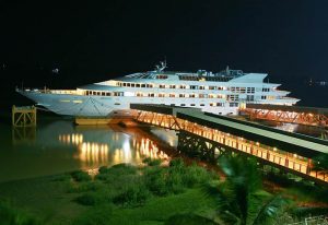 Vintage Luxury Yacht Hotel, a gay-friendly hotel. Docked yacht at night, illuminated. A unique travel experience for gay men.