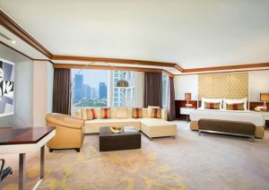 Wyndham Casablanca Jakarta gay-friendly hotel suite. Living area, city view, king bed. Upscale travel for gay men in Jakarta, Indonesia.