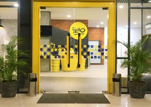 YELLO Hotel Manggarai entrance. Gay-friendly hotel with bright yellow accents and playful decor. Modern design, welcoming atmosphere.
